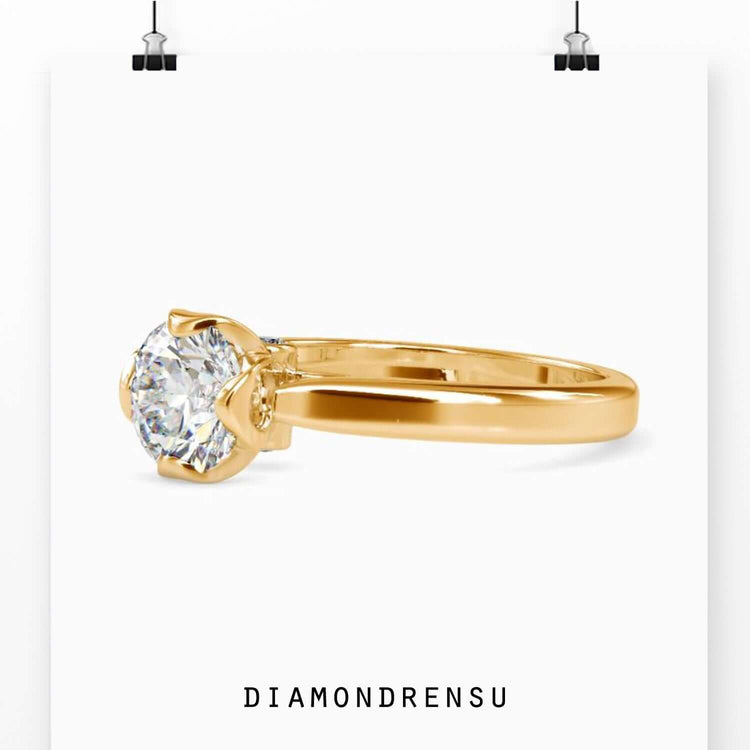 UK diamond ring in rose gold with round solitaire design.