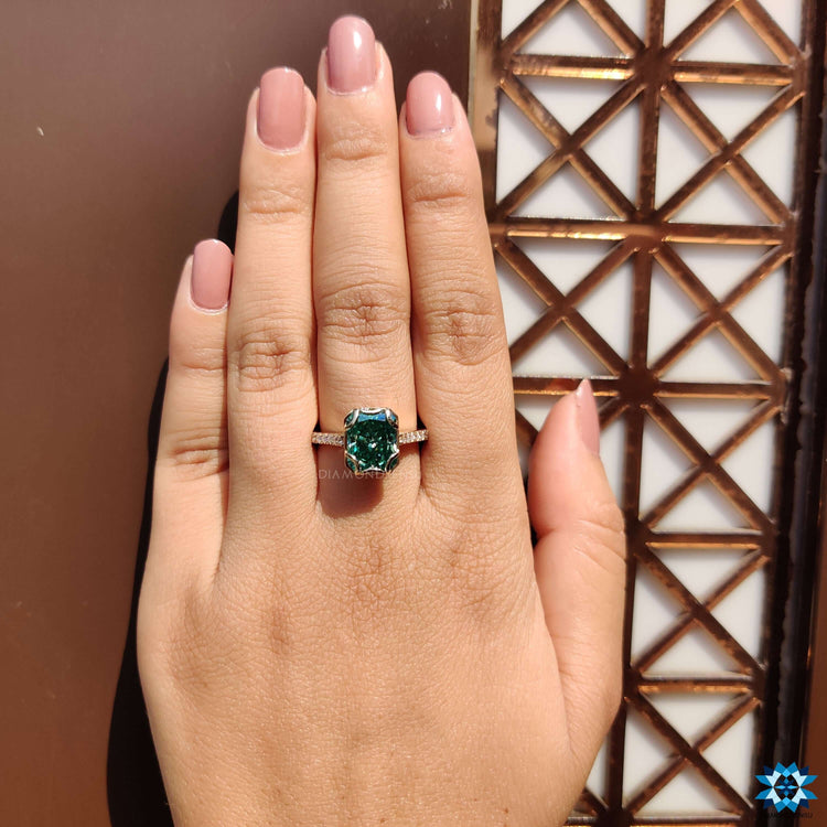Radiant cut moissanite set in a yellow gold band.
