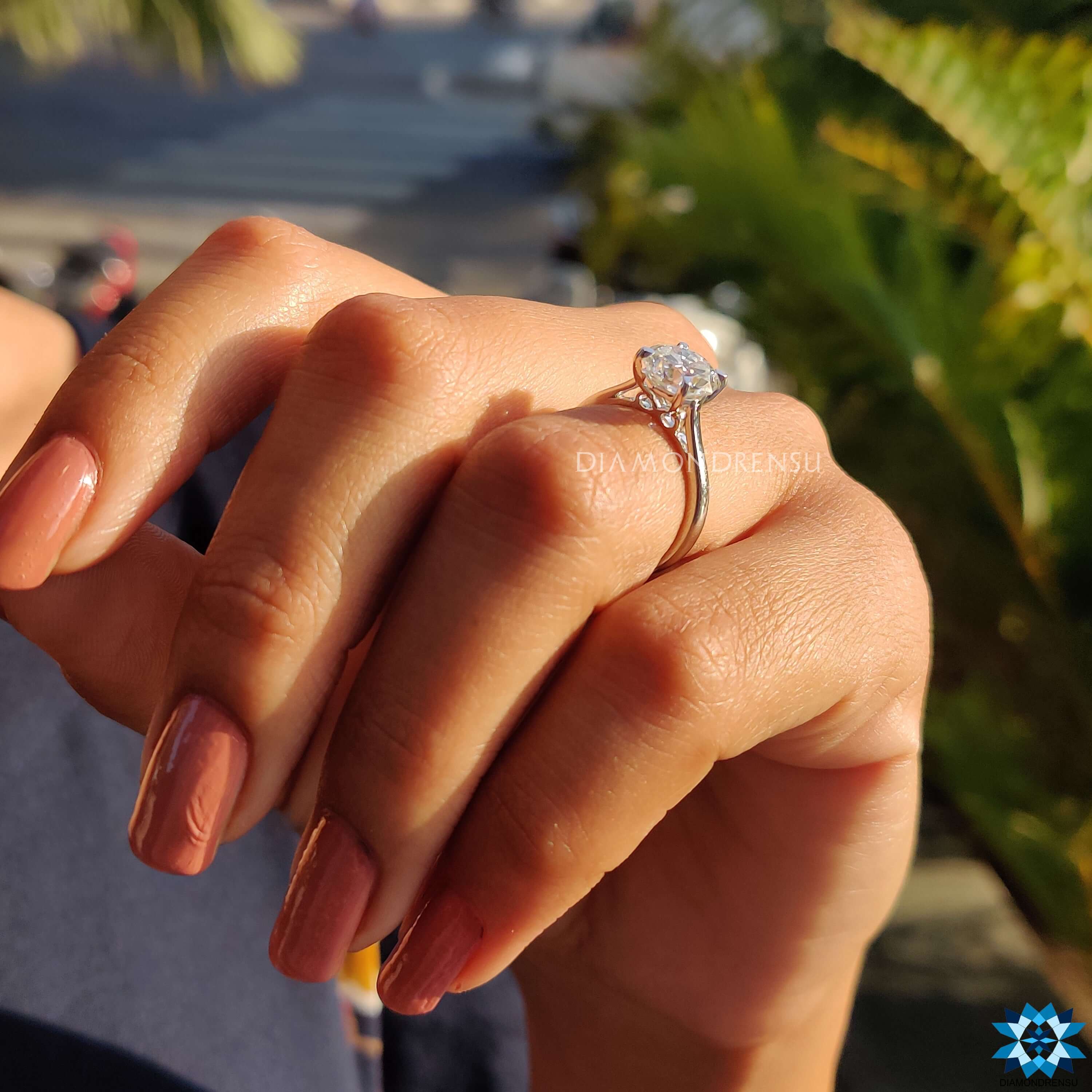 Simple moissanite ring with tab prongs and geometric cut.