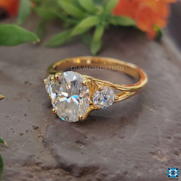 Diamondrensu UK yellow gold three stone engagement ring.