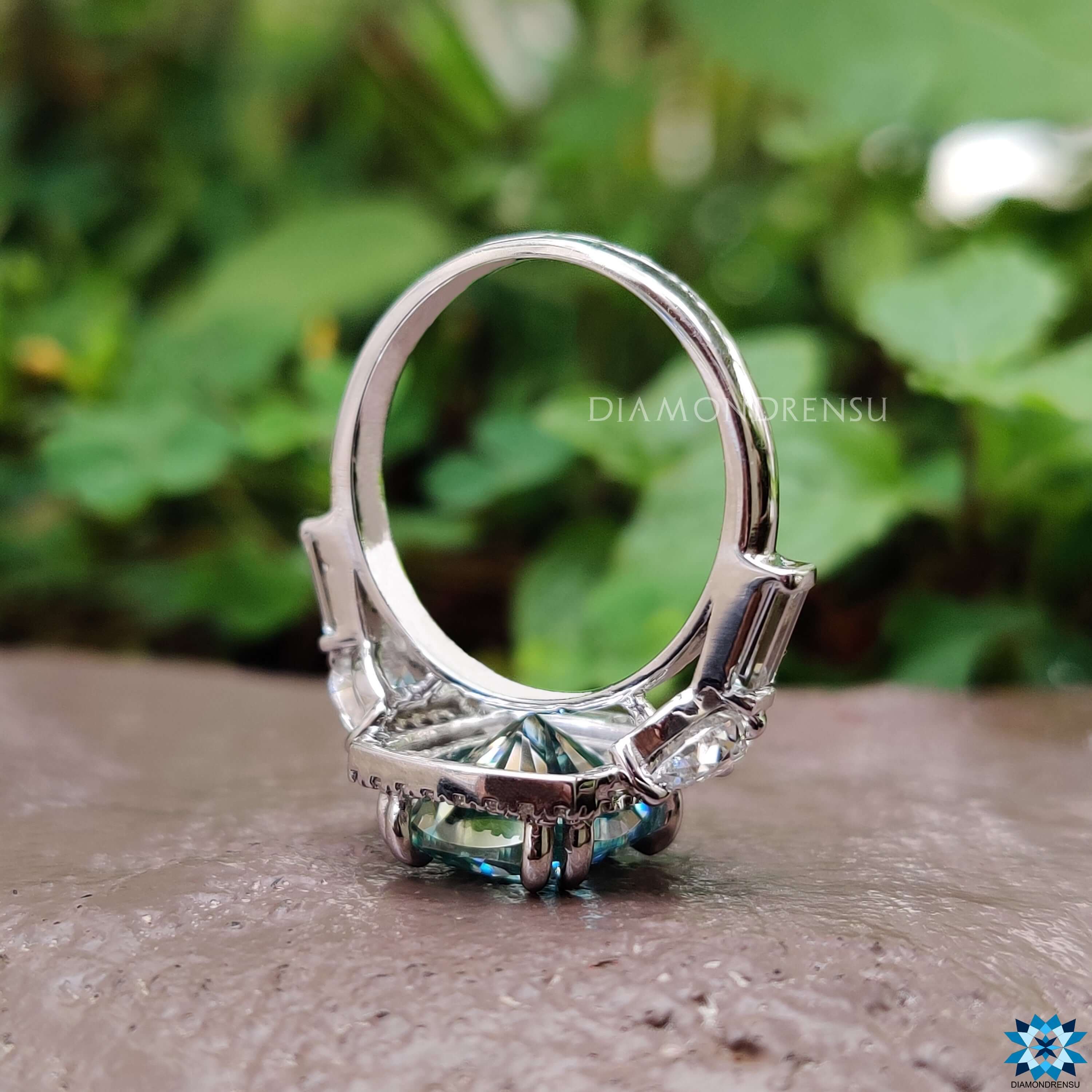 Cushion cut moissanite halo ring with mixed side stones.