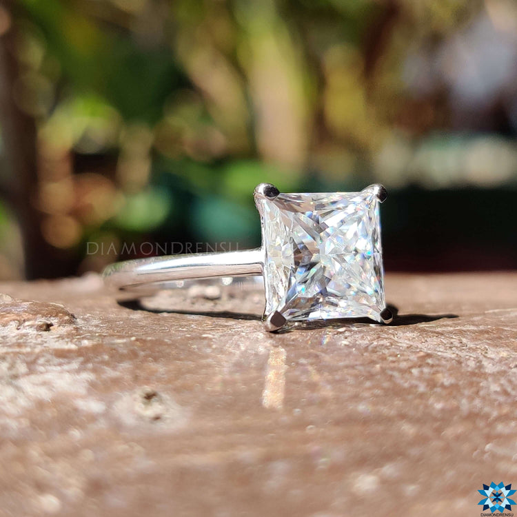 Custom engagement ring with a princess cut moissanite, designed in a solitaire style.