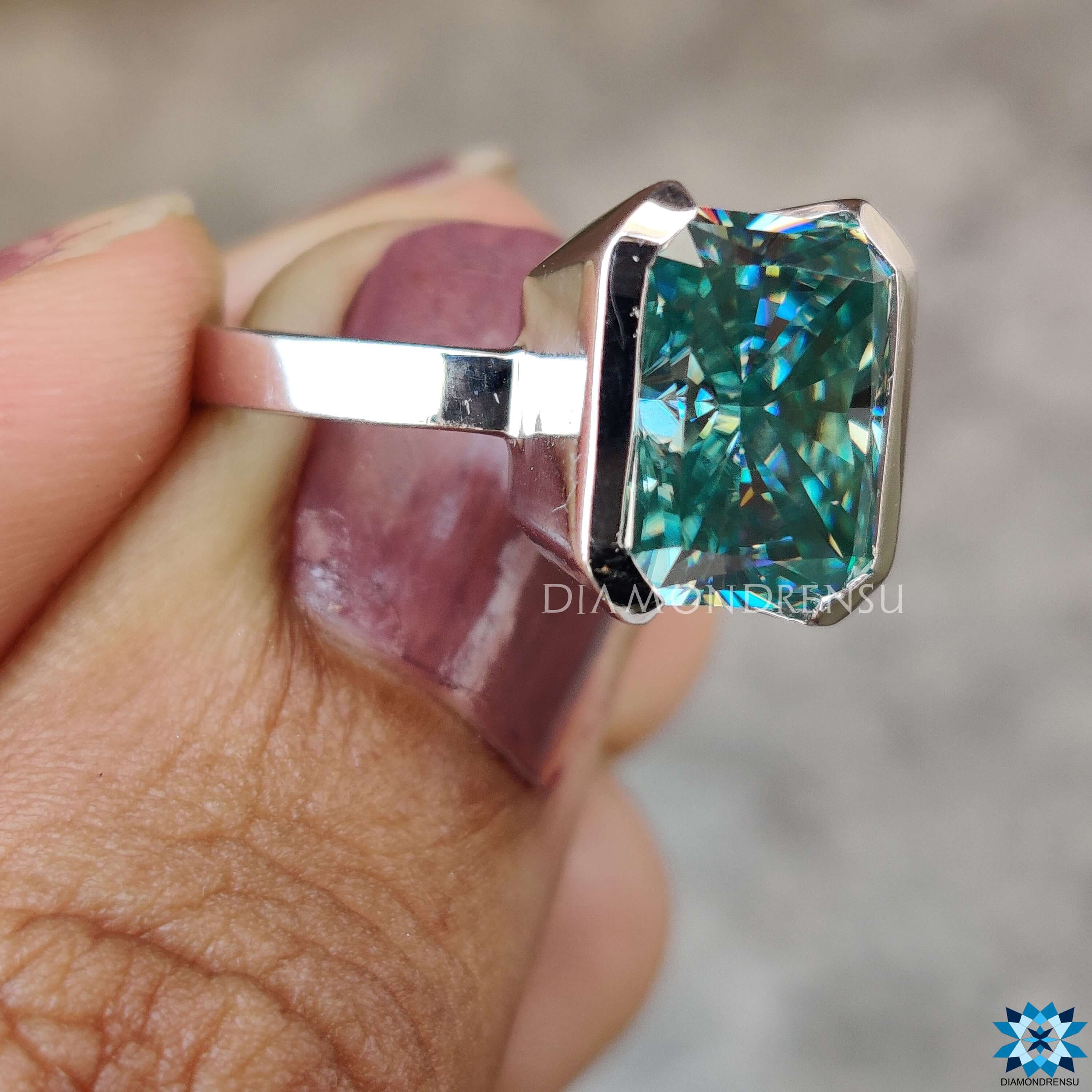 Handmade jewelry with half bezel radiant moissanite center.
