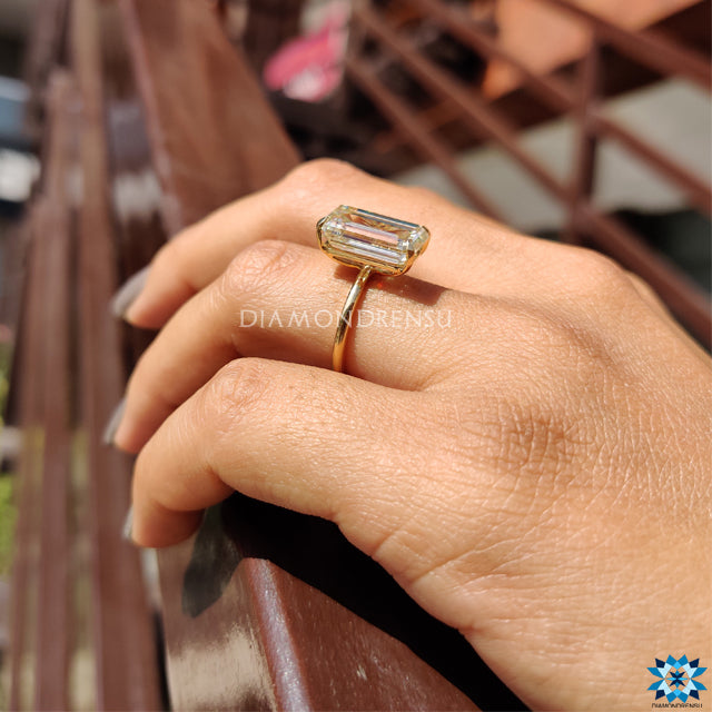 Buy moissanite ring from Diamondrensu UK with emerald cut and claw setting.