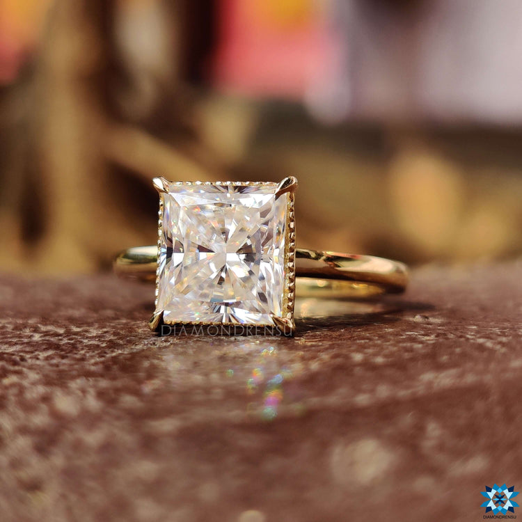 Yellow gold engagement ring with a detailed milgrain setting around the band.