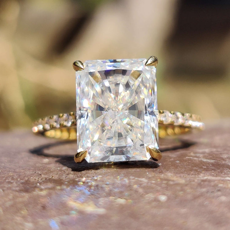 Radiant cut moissanite engagement ring in yellow gold.