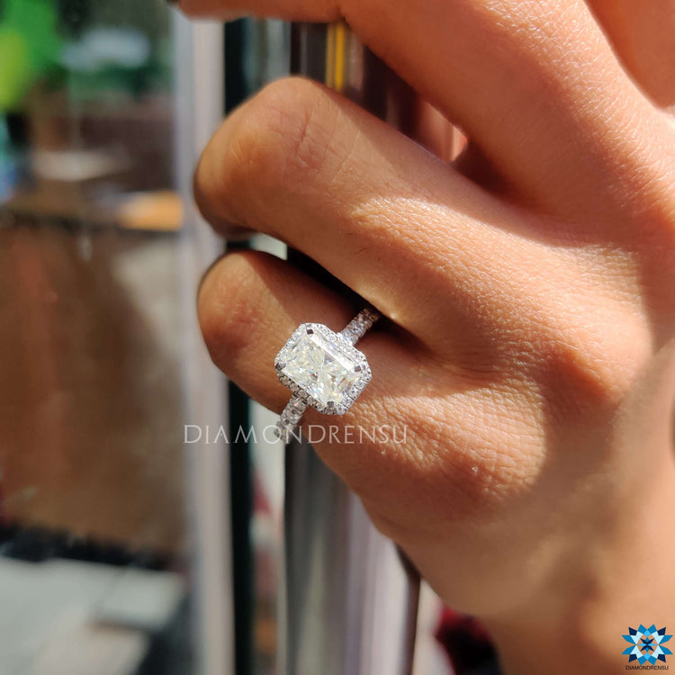 White gold moissanite ring with radiant cut center stone.