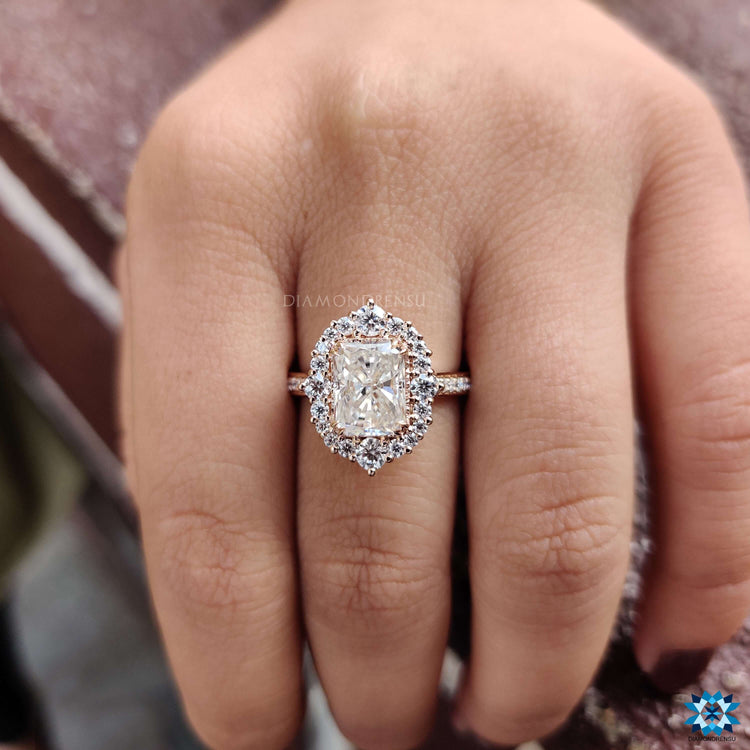 Rose gold engagement ring featuring radiant moissanite center.
