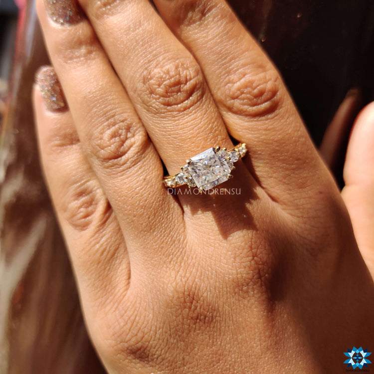 Yellow gold moissanite ring with square radiant center.