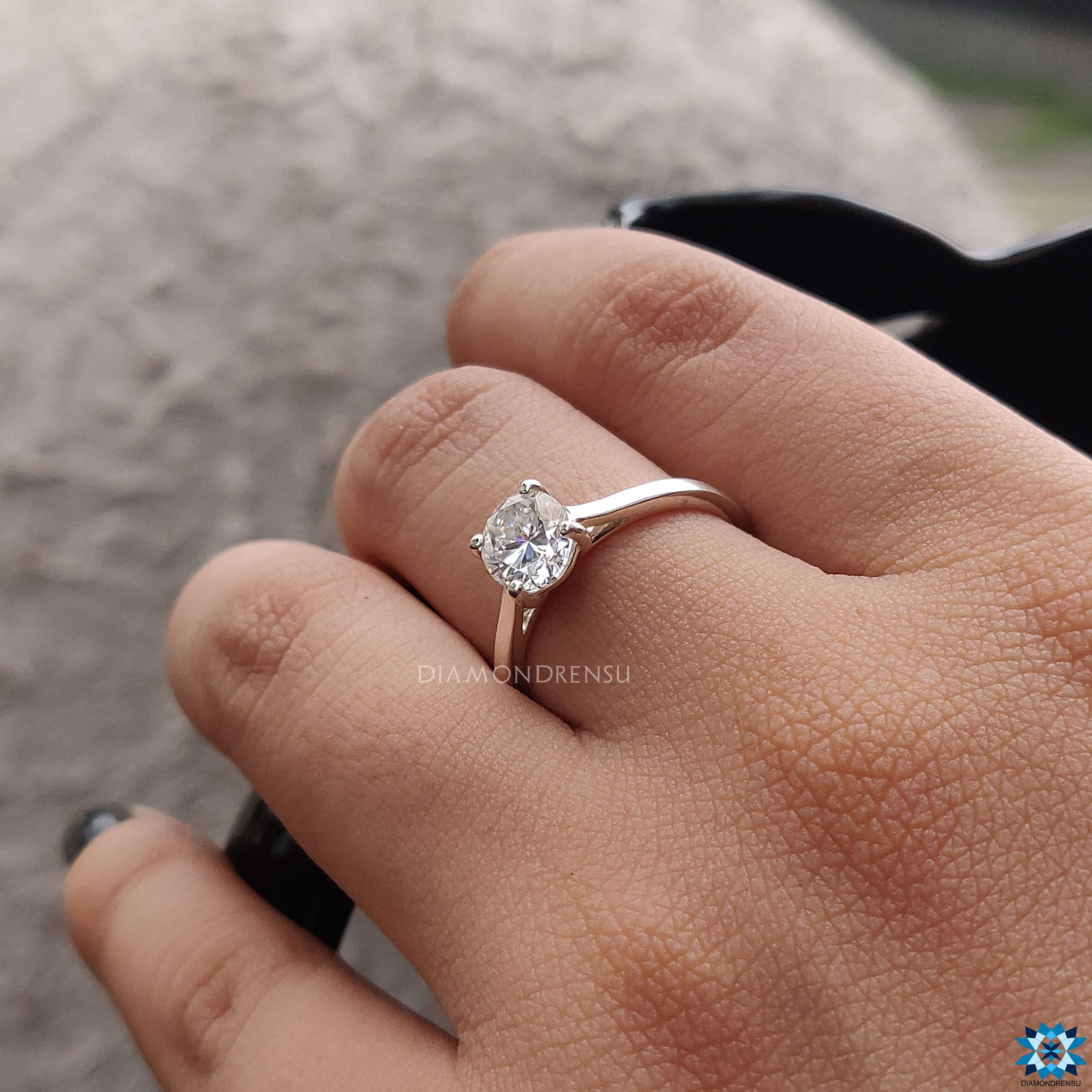 Handmade oval moissanite ring in a custom design with cathedral setting.