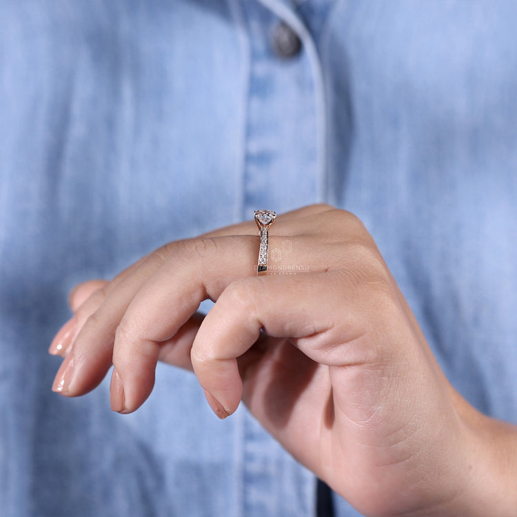 Round pave diamond ring with delicate prong setting for brilliance.