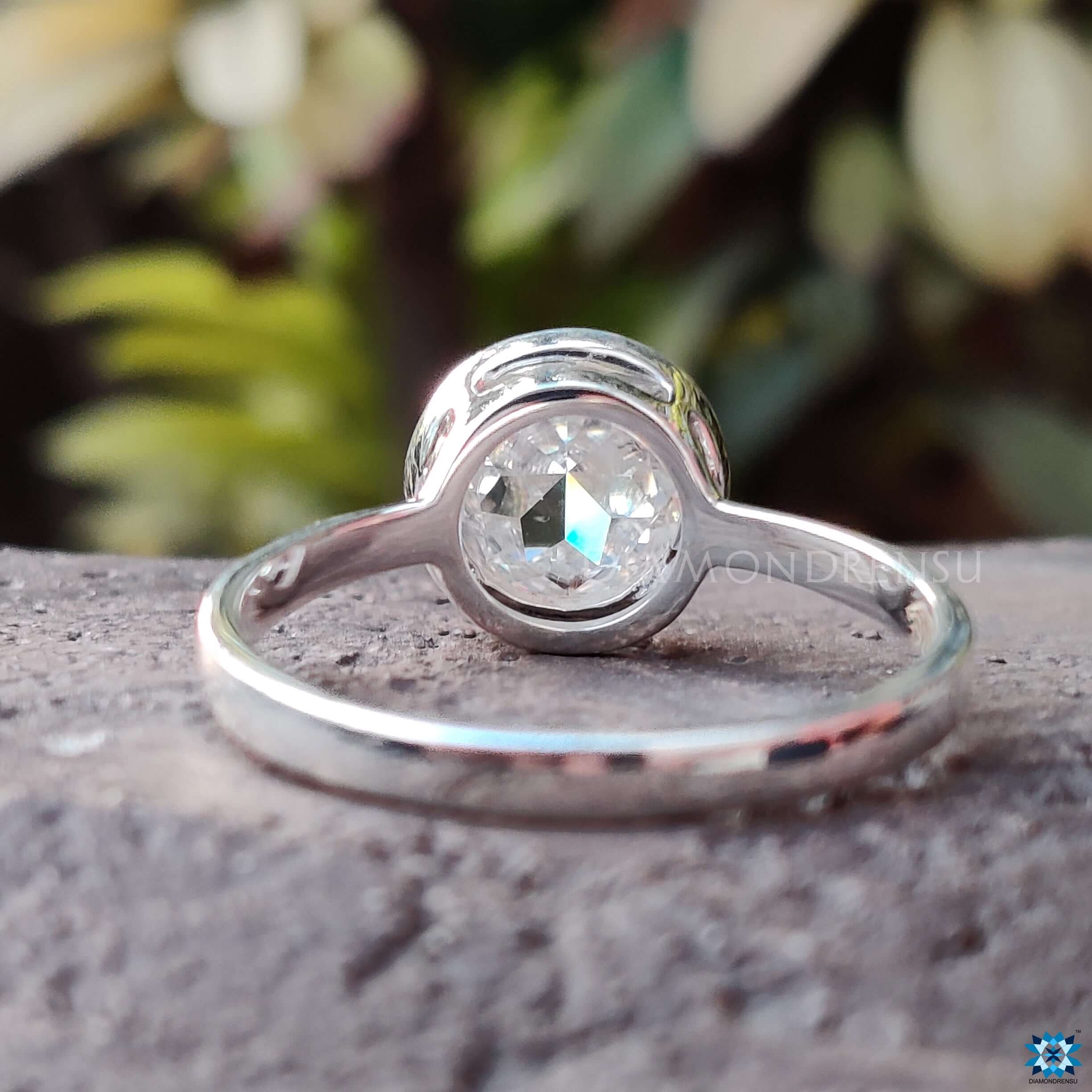 Custom Moissanite solitaire ring featuring round rose cut stone in a bezel setting.