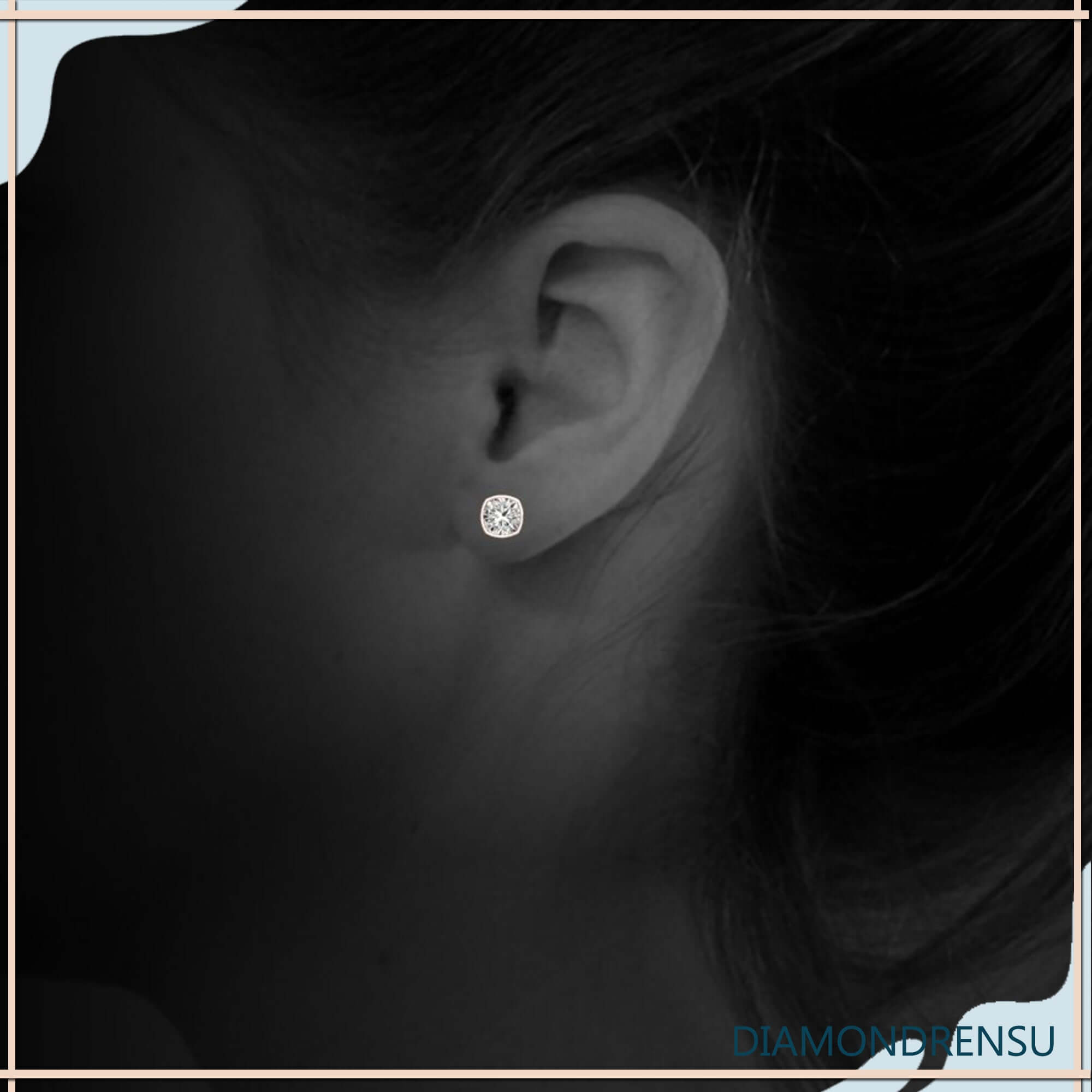 Handmade bezel set cushion cut diamond stud earrings.