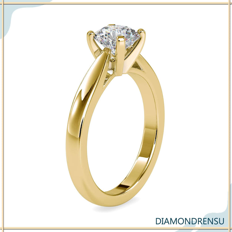 Designer ring with round diamond and yellow gold band.