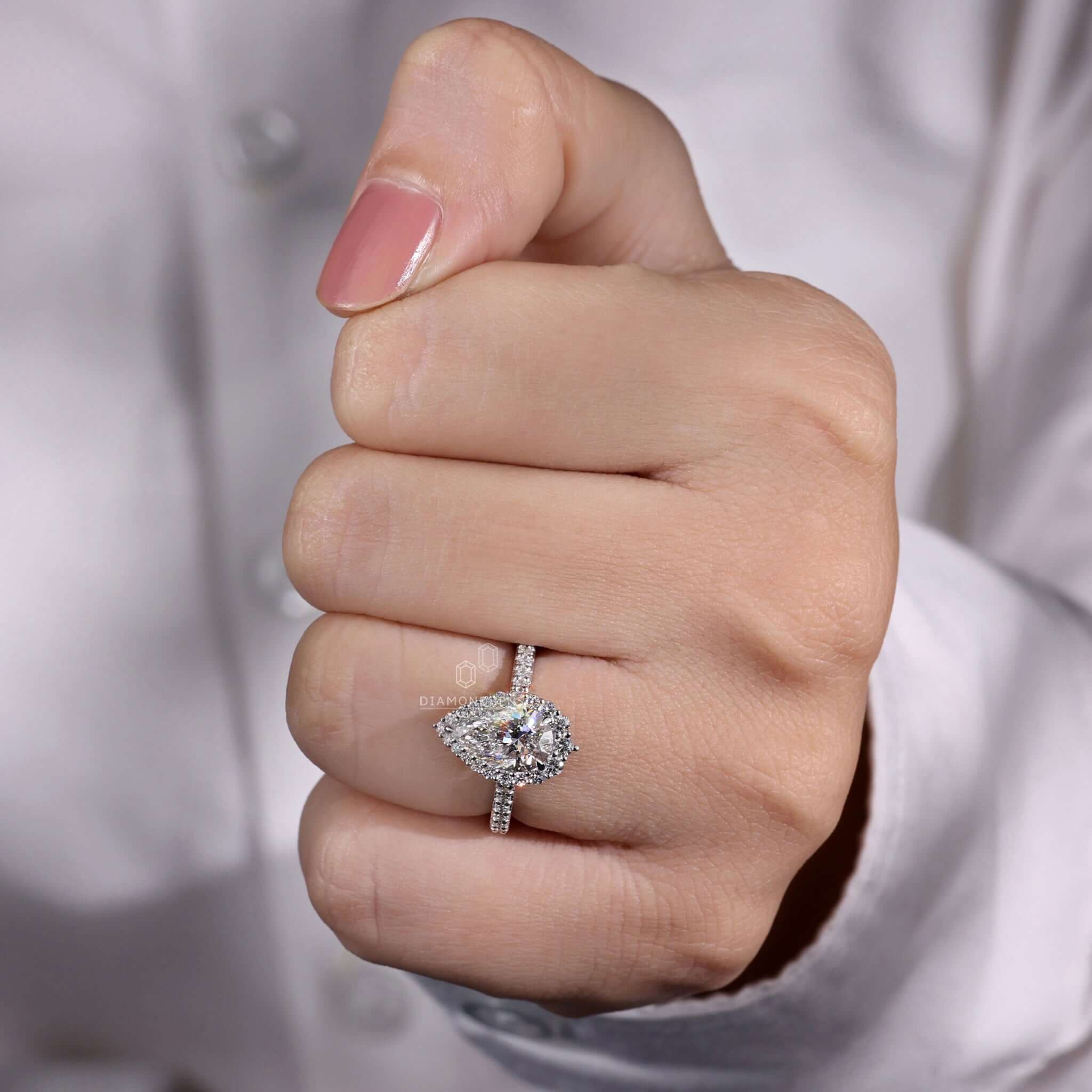 Pear shape diamond ring featuring claw prong setting design.