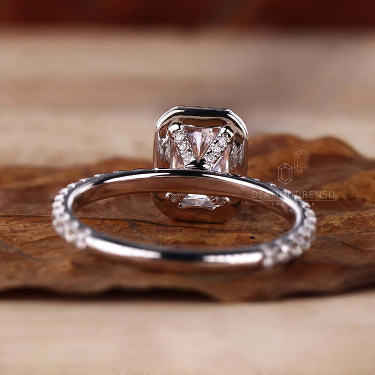 Radiant ring in a halo engagement ring style with claw prong setting and lab grown diamond craftsmanship.