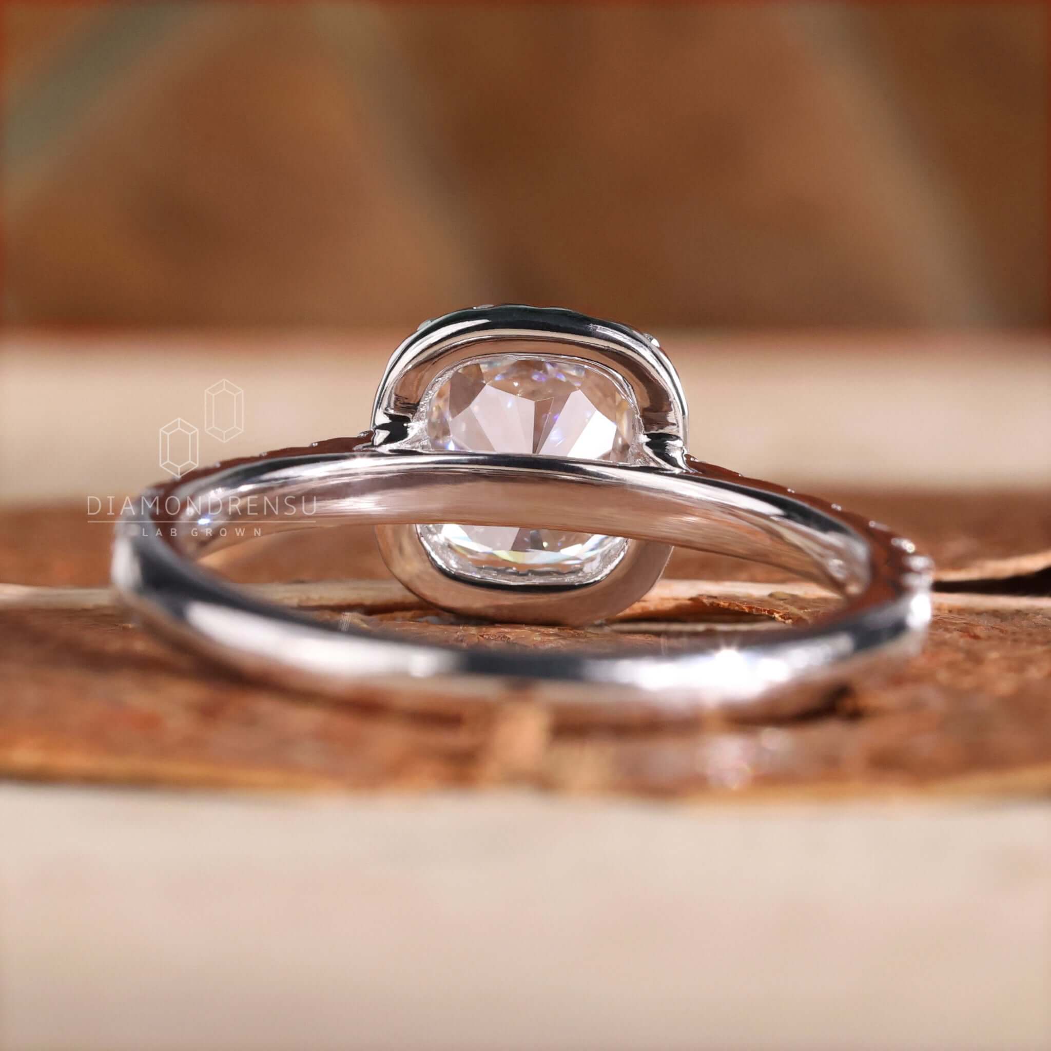 Cushion cut diamond ring featuring a pave band and white gold finish