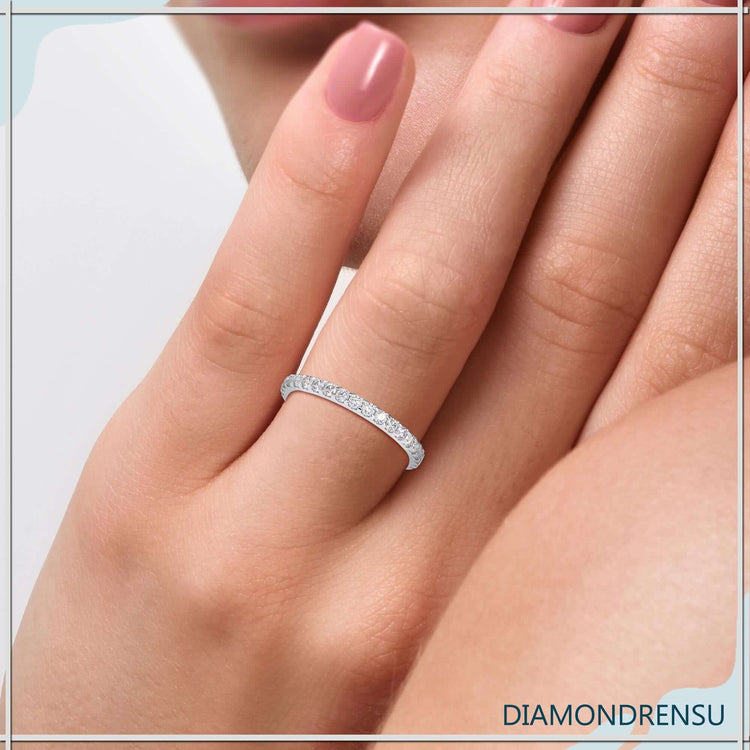Round diamond wedding band in white gold with French cut pavé.
