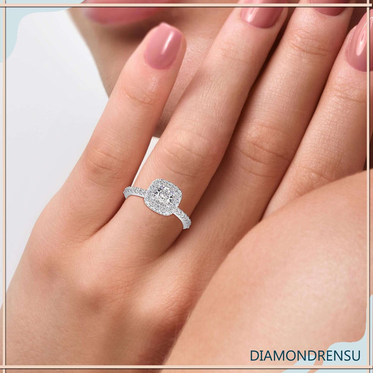 Halo diamond engagement ring featuring round cut pave band.