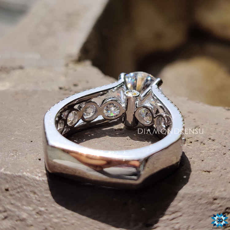 White gold engagement ring with round side stones.