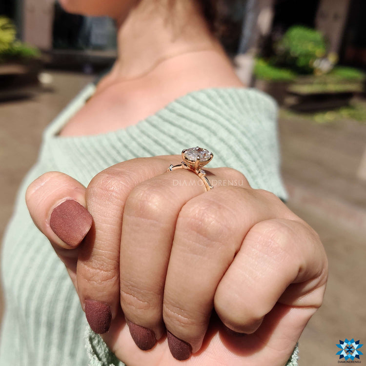 Oval moissanite ring with distance pave band.