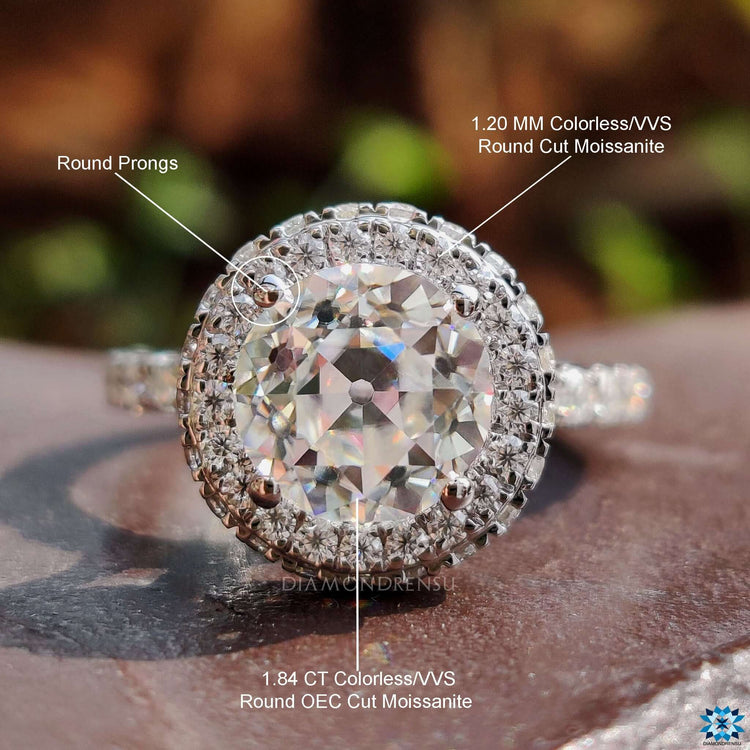 Round cut engagement ring with pave setting and side halo.