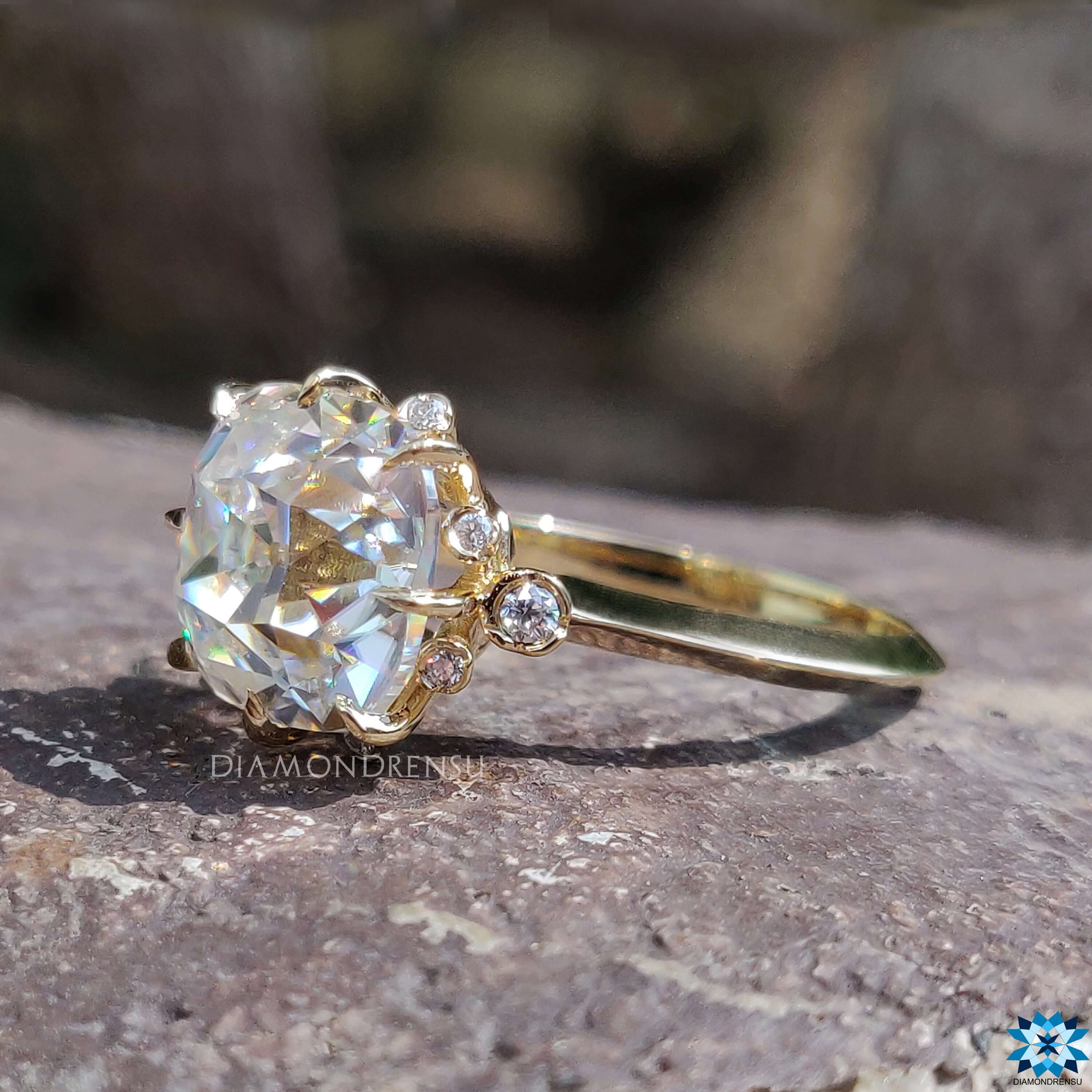 Yellow gold engagement ring with cushion old mine cut center.