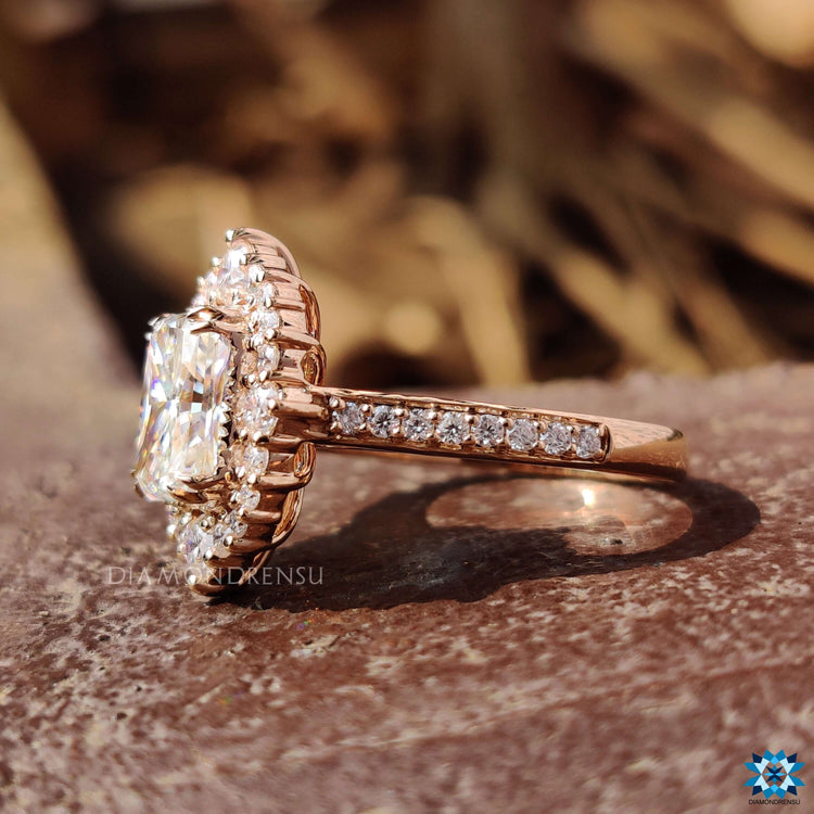 Halo engagement ring with radiant cut moissanite and rose gold.