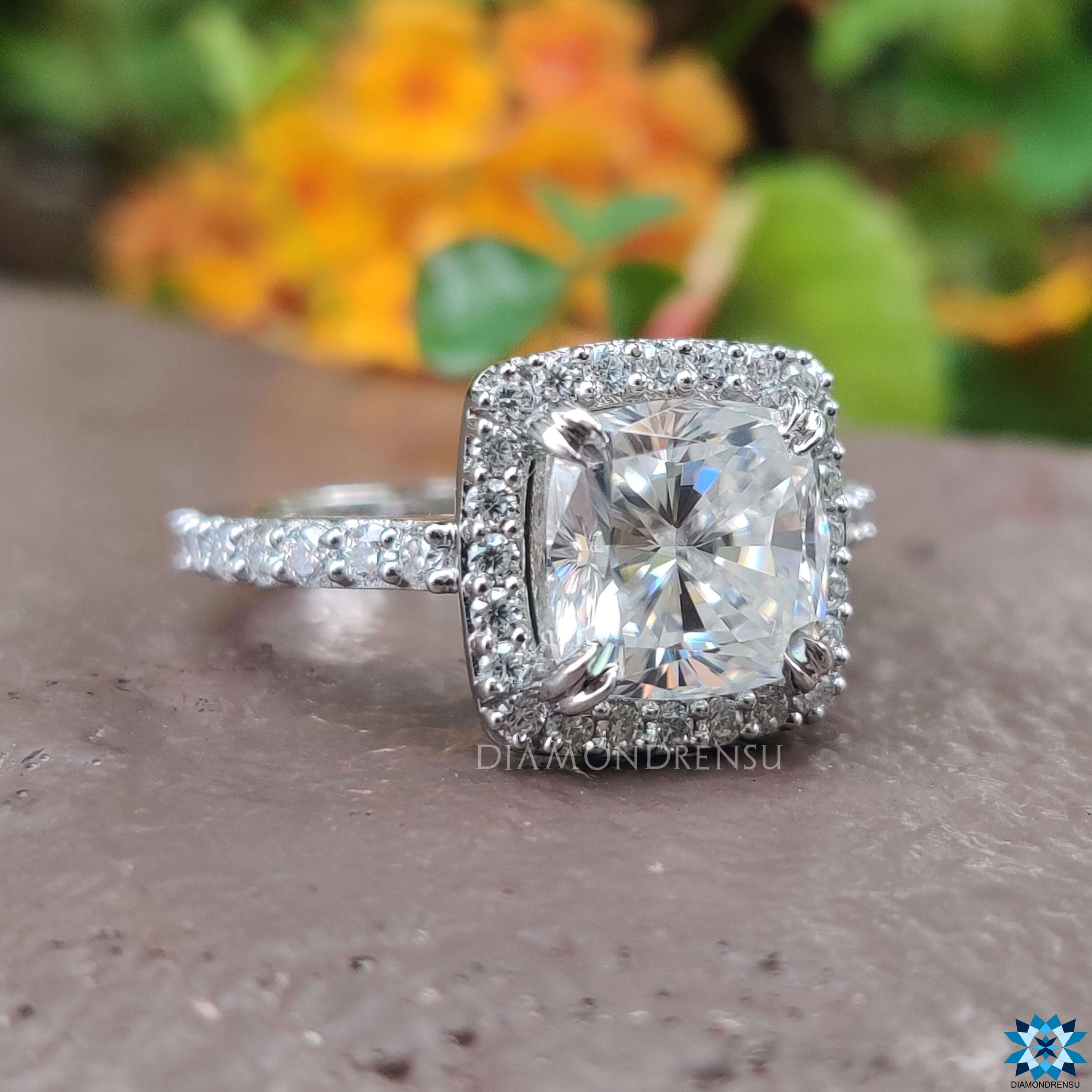 Handmade moissanite ring with double claw prong and pavé band.