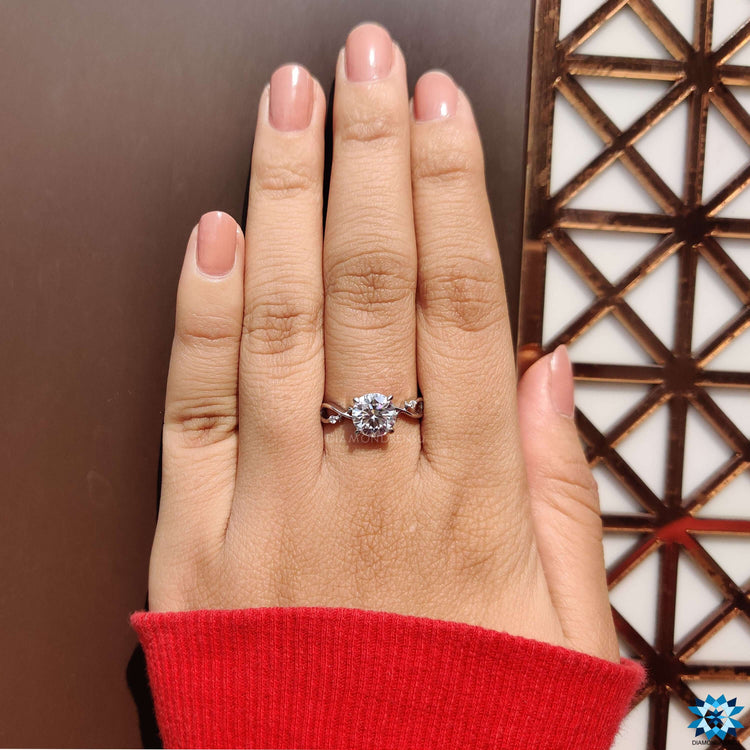 Round moissanite ring in white gold.