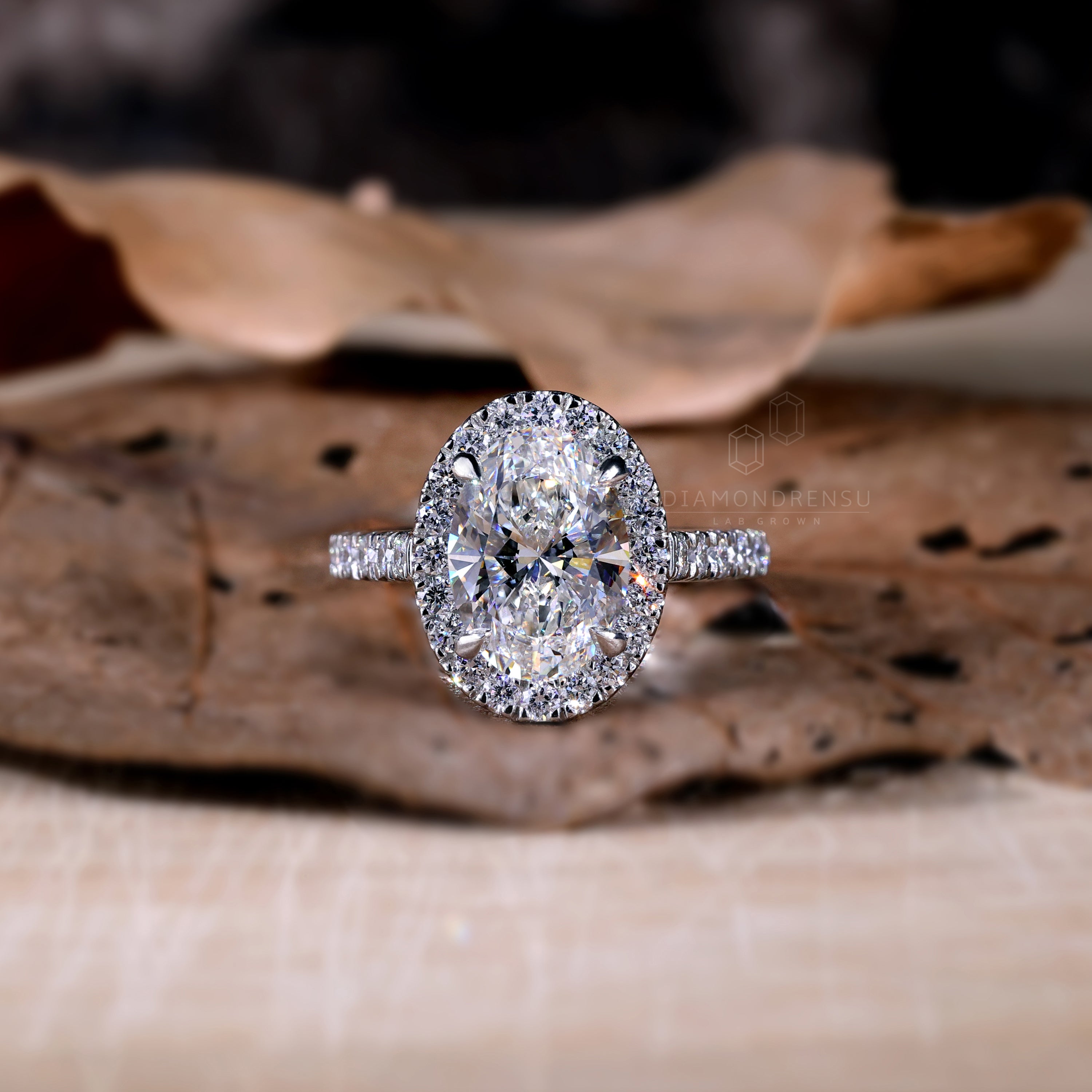 Classic oval diamond halo ring in a handmade jewellery finish.