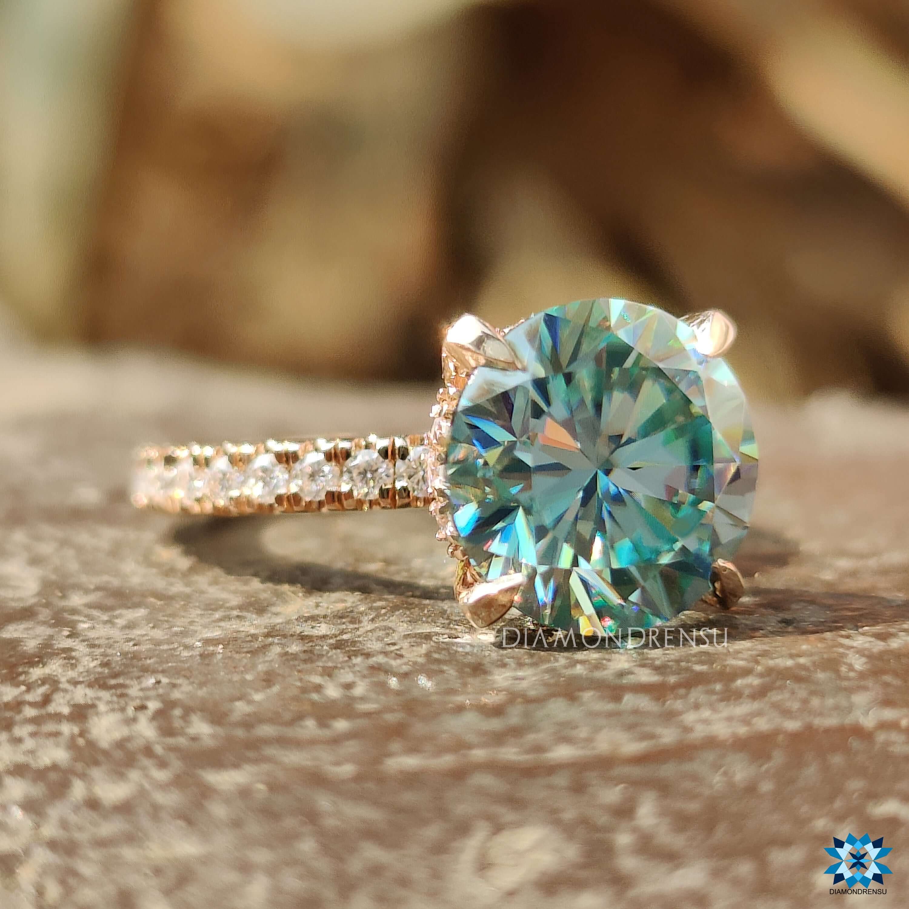 Rose gold moissanite pave ring with round cut center.
