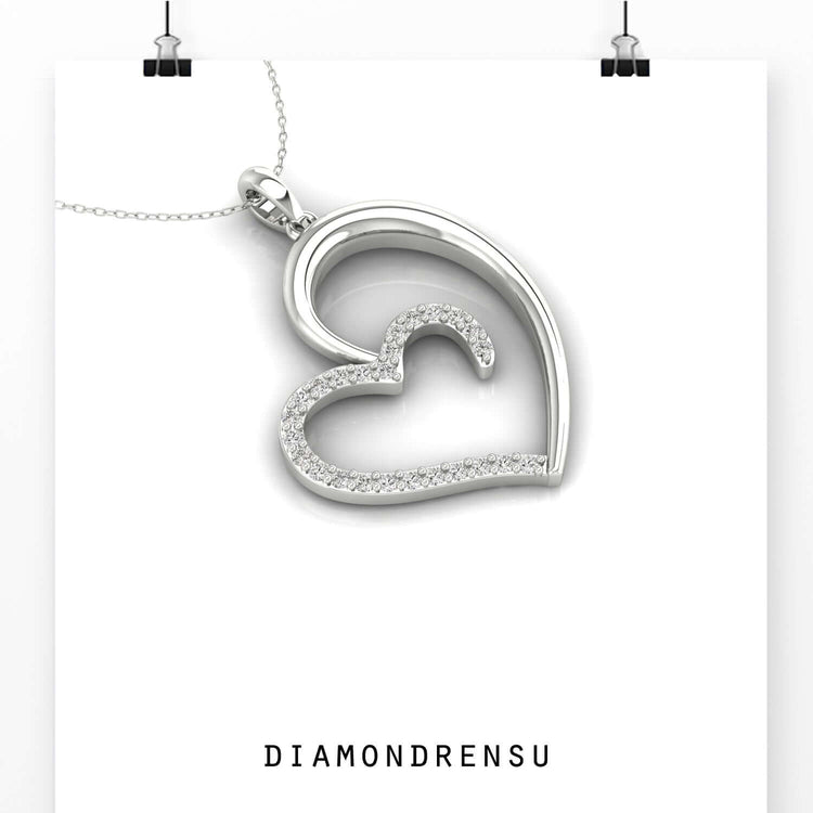 Rose gold pendant featuring heart design and diamond accent.