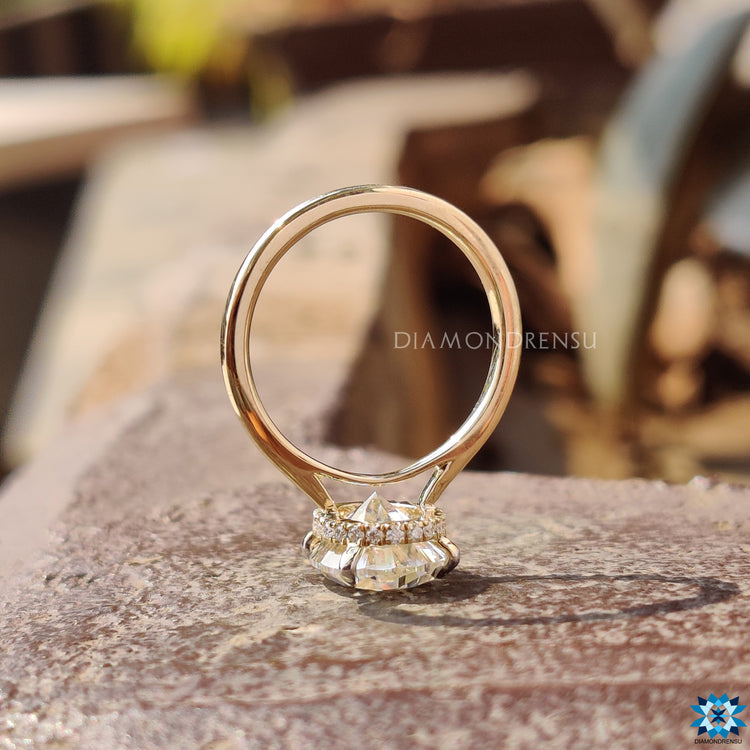 UK engagement ring with oval cut moissanite and claw prong mount.