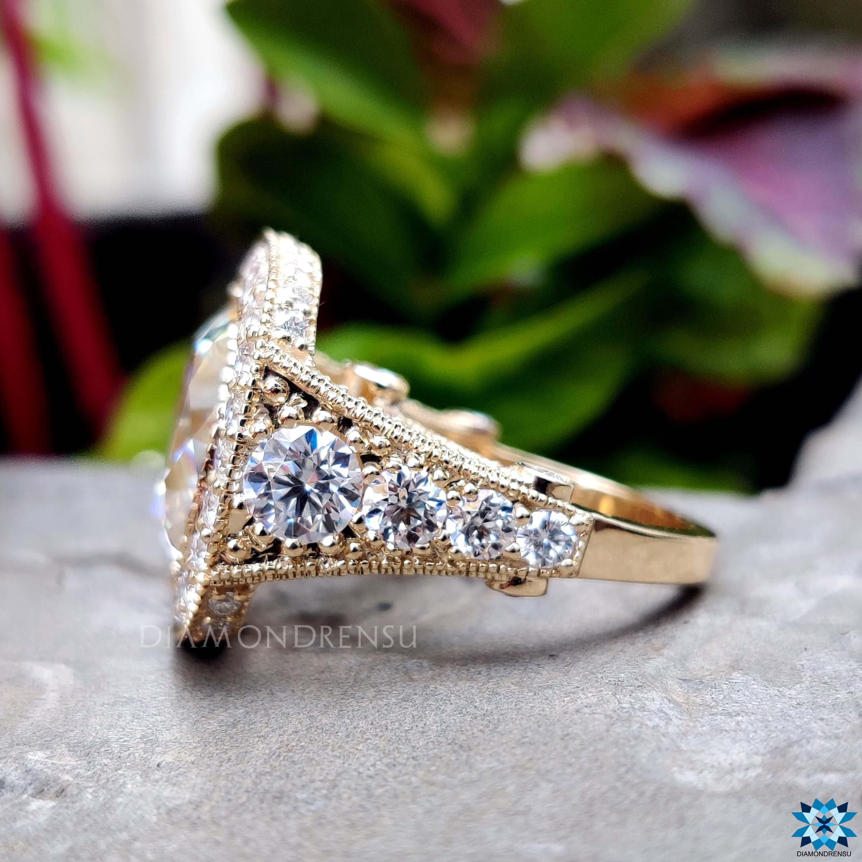 Vintage-inspired engagement ring with cushion cut center stone.