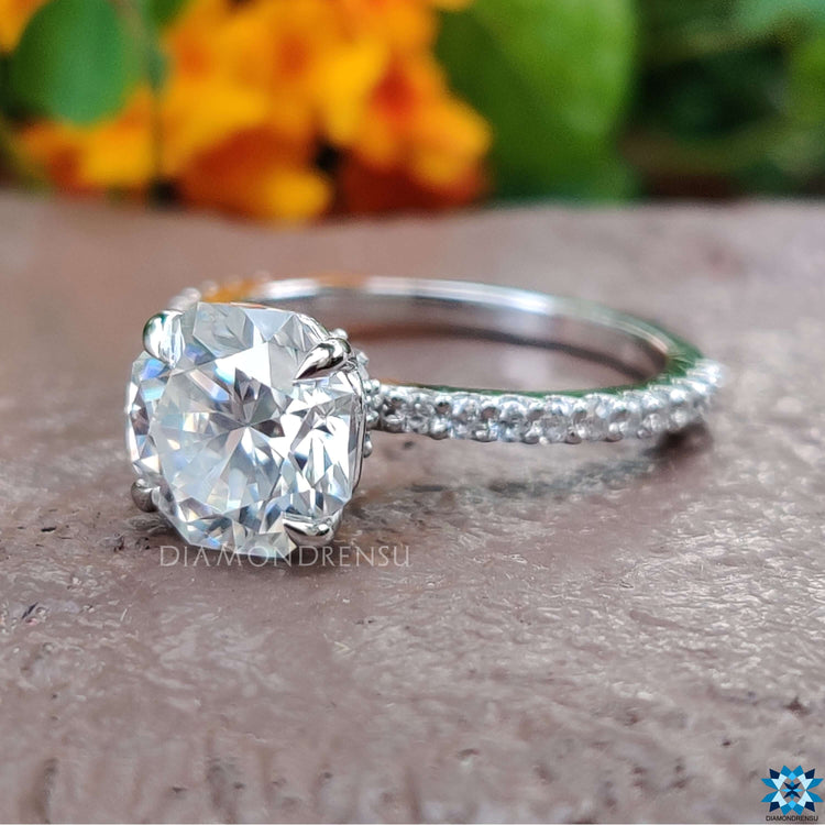 White gold engagement ring featuring hidden halo and pave.