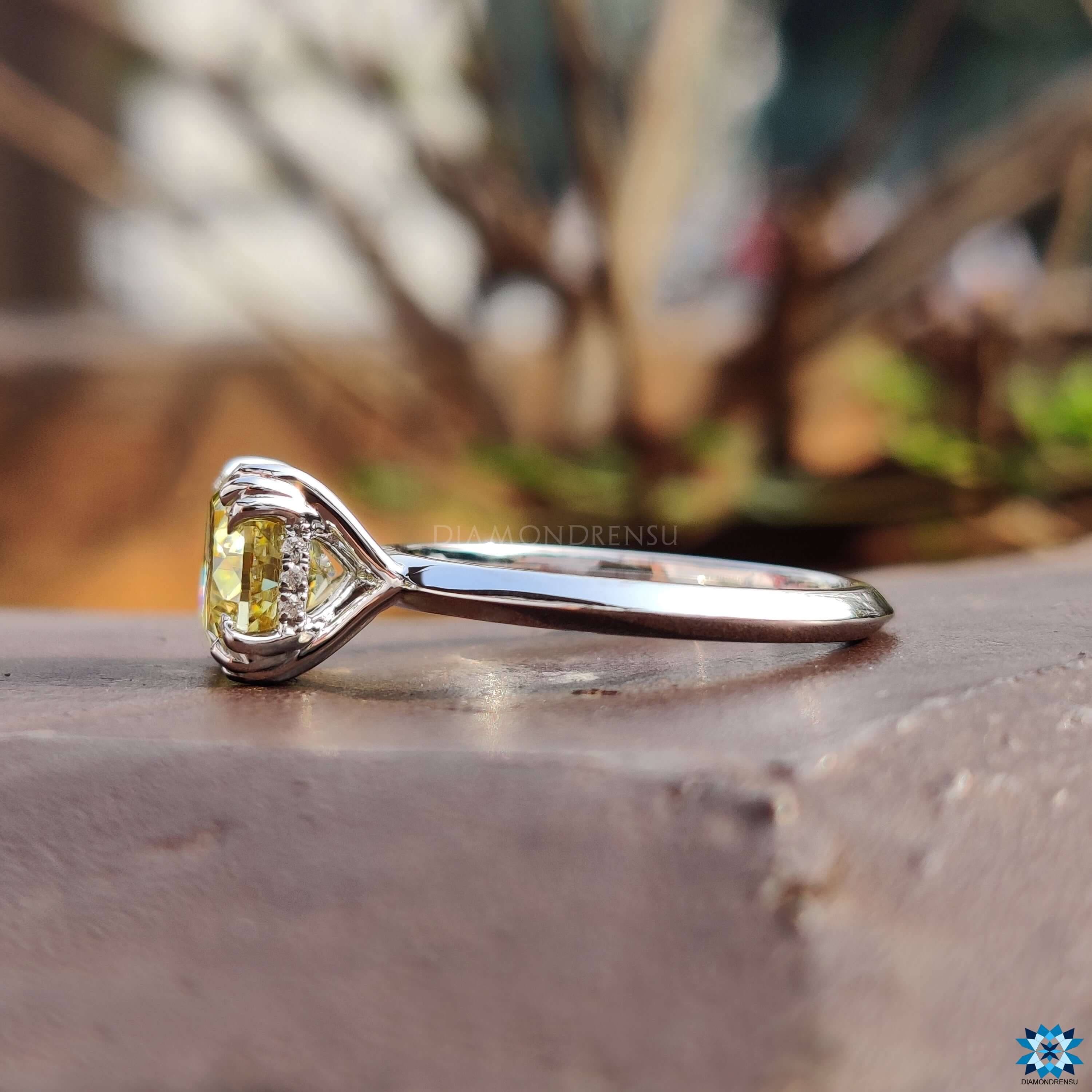 Cushion cut moissanite ring with fishtail prong setting.