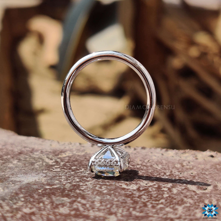 White gold moissanite ring with 4 prong claw setting.