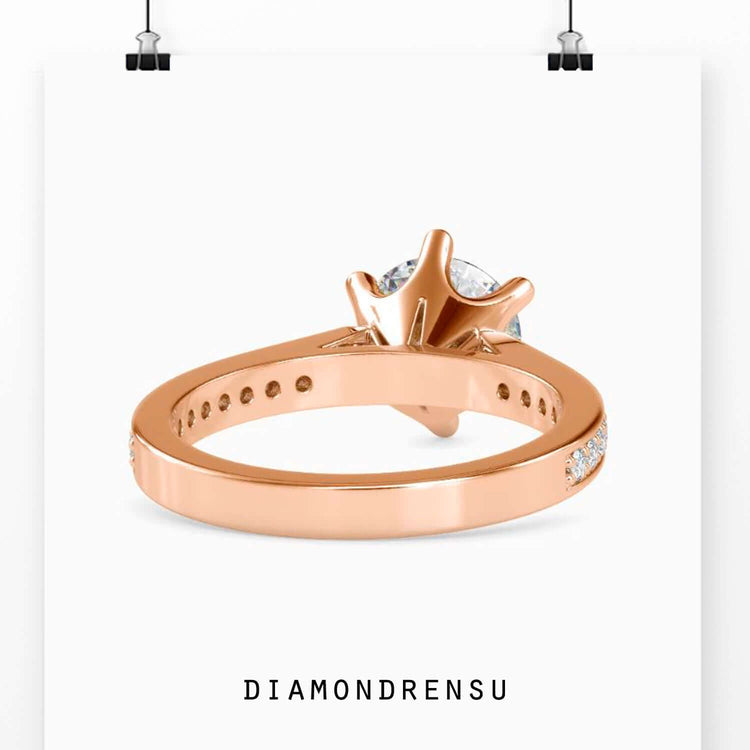 Round prong setting engagement ring in rose gold channel design.