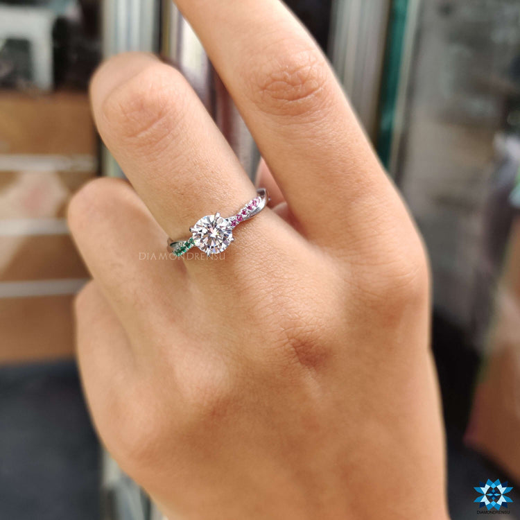 White gold custom ring featuring round moissanite and gems.