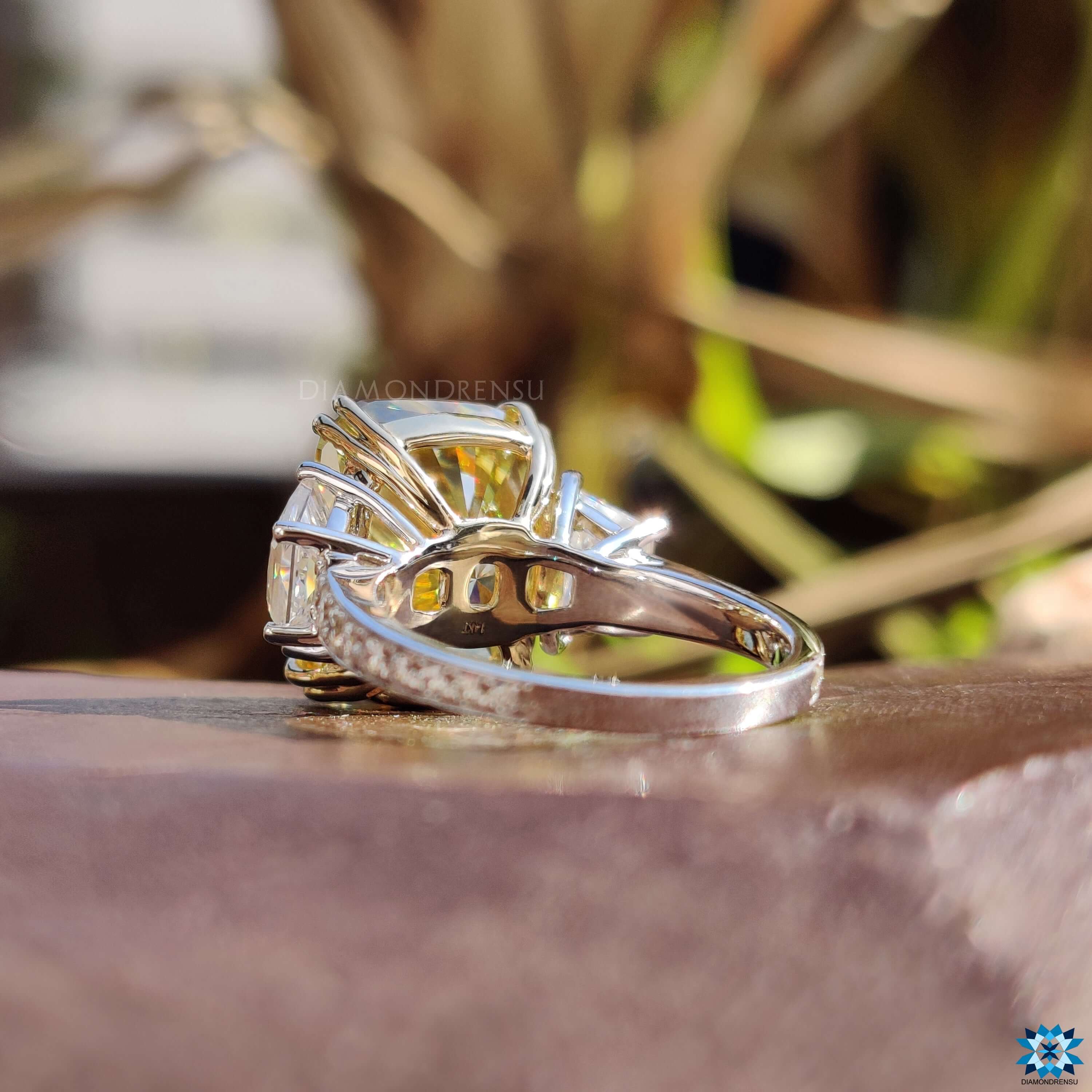 Trapezoid cut moissanite side stones in white gold setting.