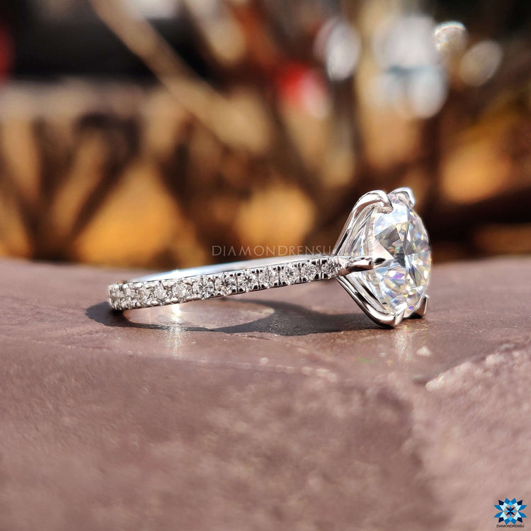 Round cut engagement ring with pave details.