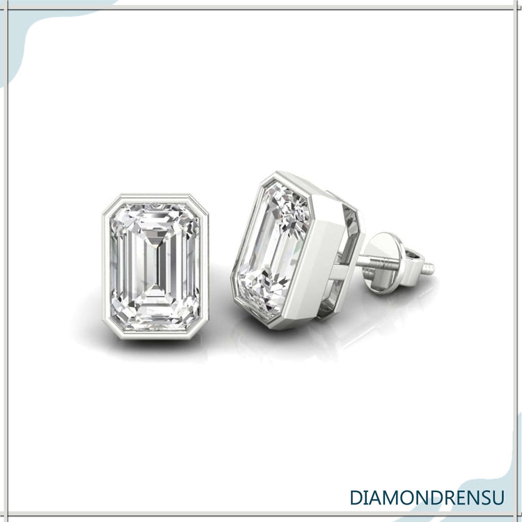 Diamond stud earrings with emerald cut stones in rose gold bezel.