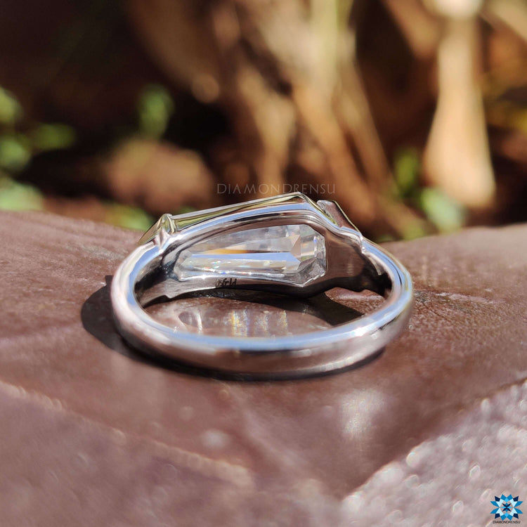 East west engagement ring featuring shield cut moissanite.