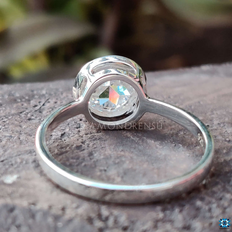 Handmade jewellery piece with bezel set Moissanite in classic solitaire style.