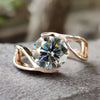Tension setting engagement ring with round gray moissanite.