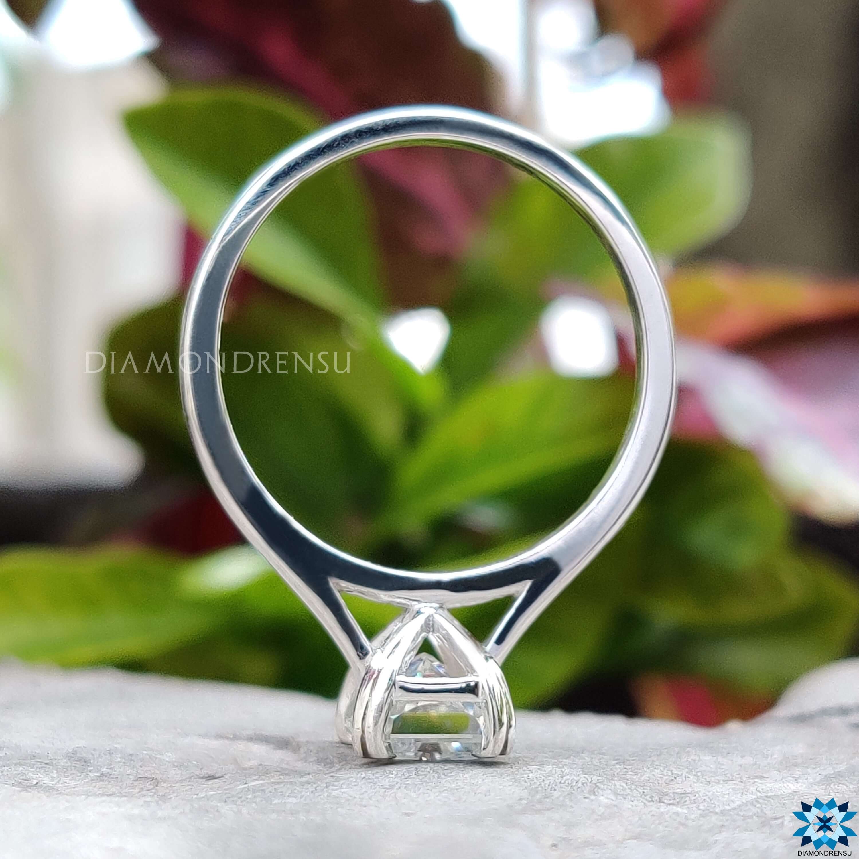 Custom radiant cut solitaire ring in cathedral setting.
