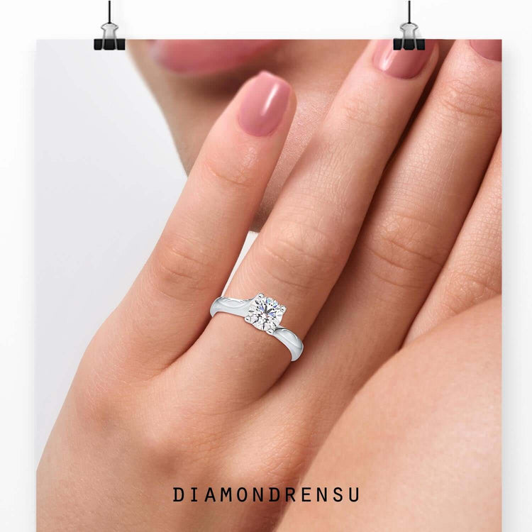 Round cut diamond set in bypass white gold band.