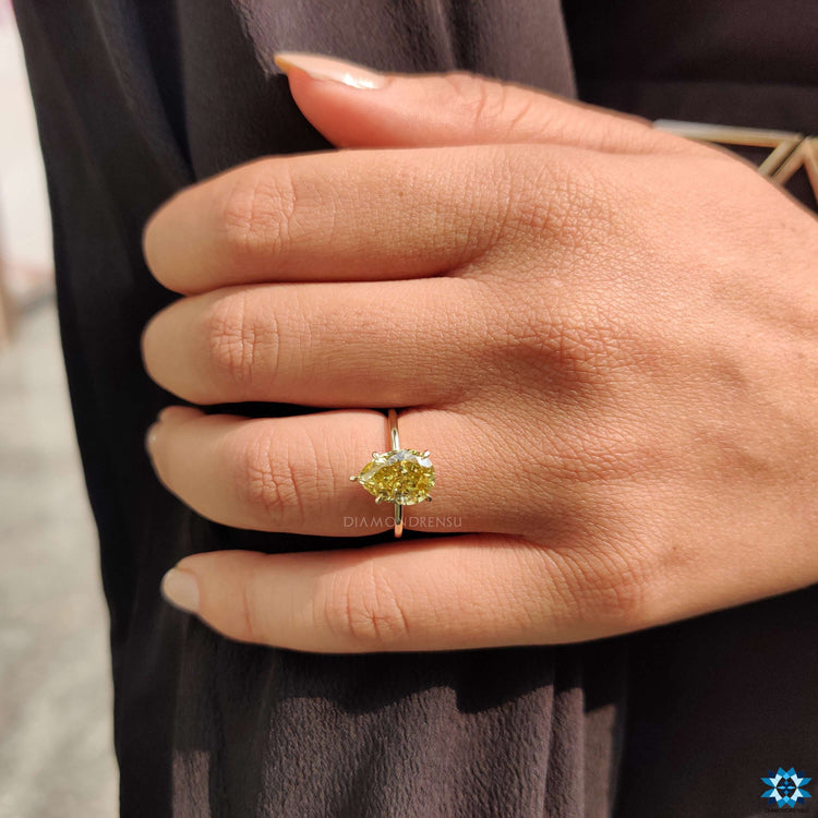 Handmade moissanite ring in yellow gold.