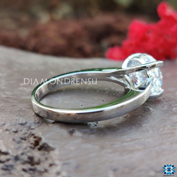 Elegant solitaire ring with 4-tab prong setting.